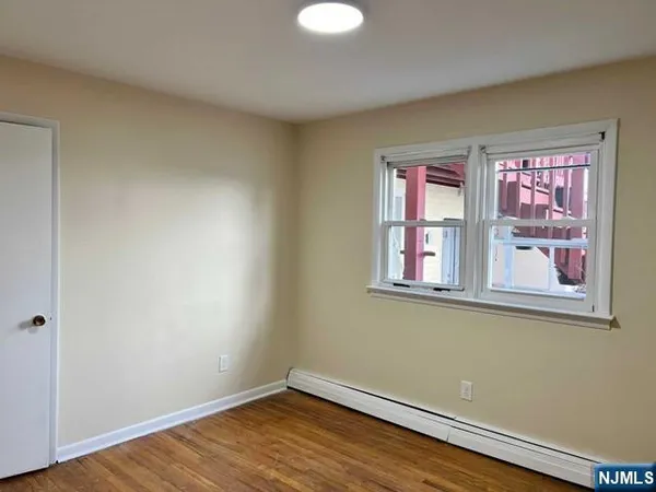 a view of a room with wooden floor and windows