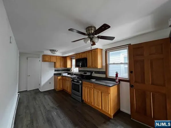 a kitchen with a stove a sink and a refrigerator