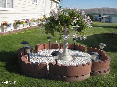 181 Schut Road, Unit 8 Moxee, WA 98936 - Photo 19 of 20 a view of a house with backyard and sitting area