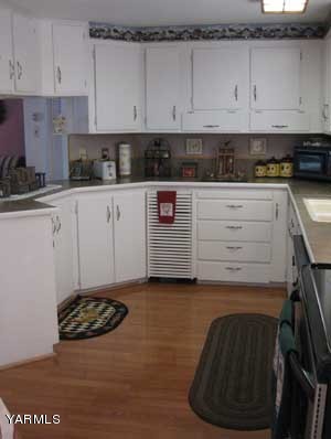 181 Schut Road, Unit 8 Moxee, WA 98936 - Photo 4 of 20 a kitchen with a white cabinets and a stove