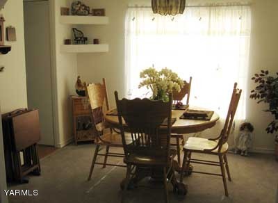 181 Schut Road, Unit 8 Moxee, WA 98936 - Photo 7 of 20 a view of a dining room with furniture and a window