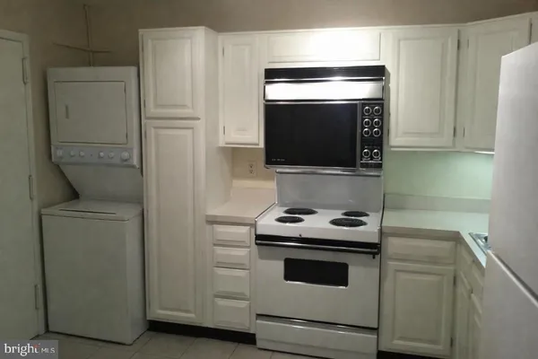 a kitchen with a stove and a microwave