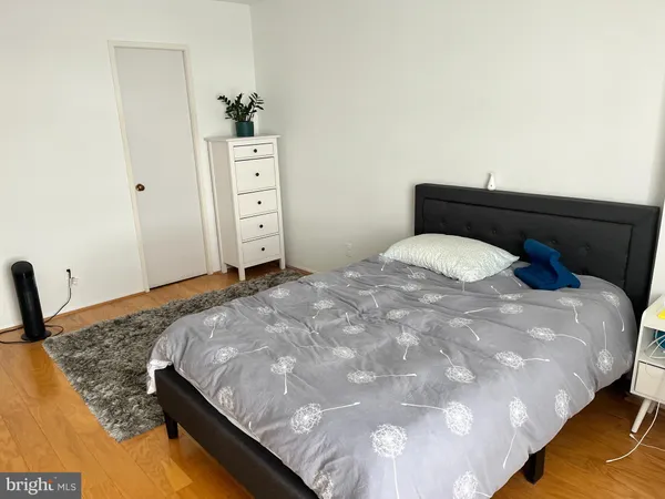 a bedroom with a bed and painting on the wall