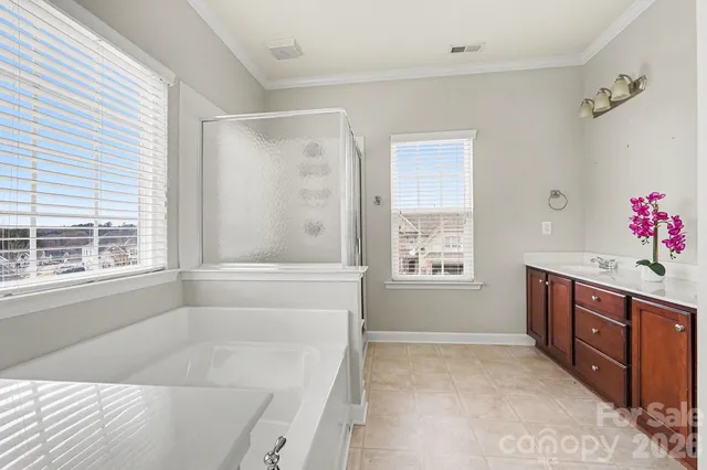 an empty room with a window and a ceiling fan