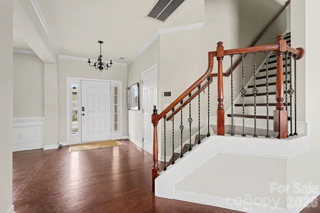 a view of entryway and hall with wooden floor