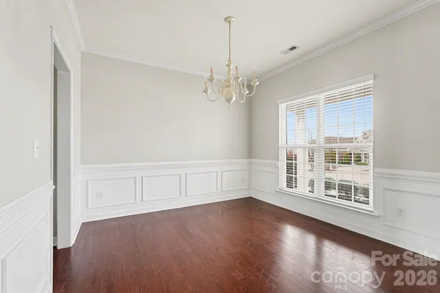 a view of a livingroom with wooden floor and a large window