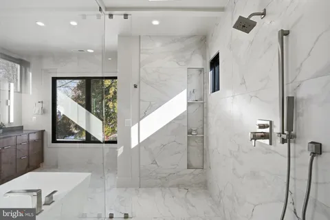 a kitchen with stainless steel appliances granite countertop a sink and a refrigerator