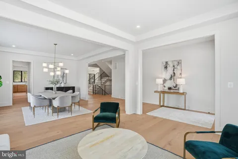 a dining room with furniture a chandelier and wooden floor