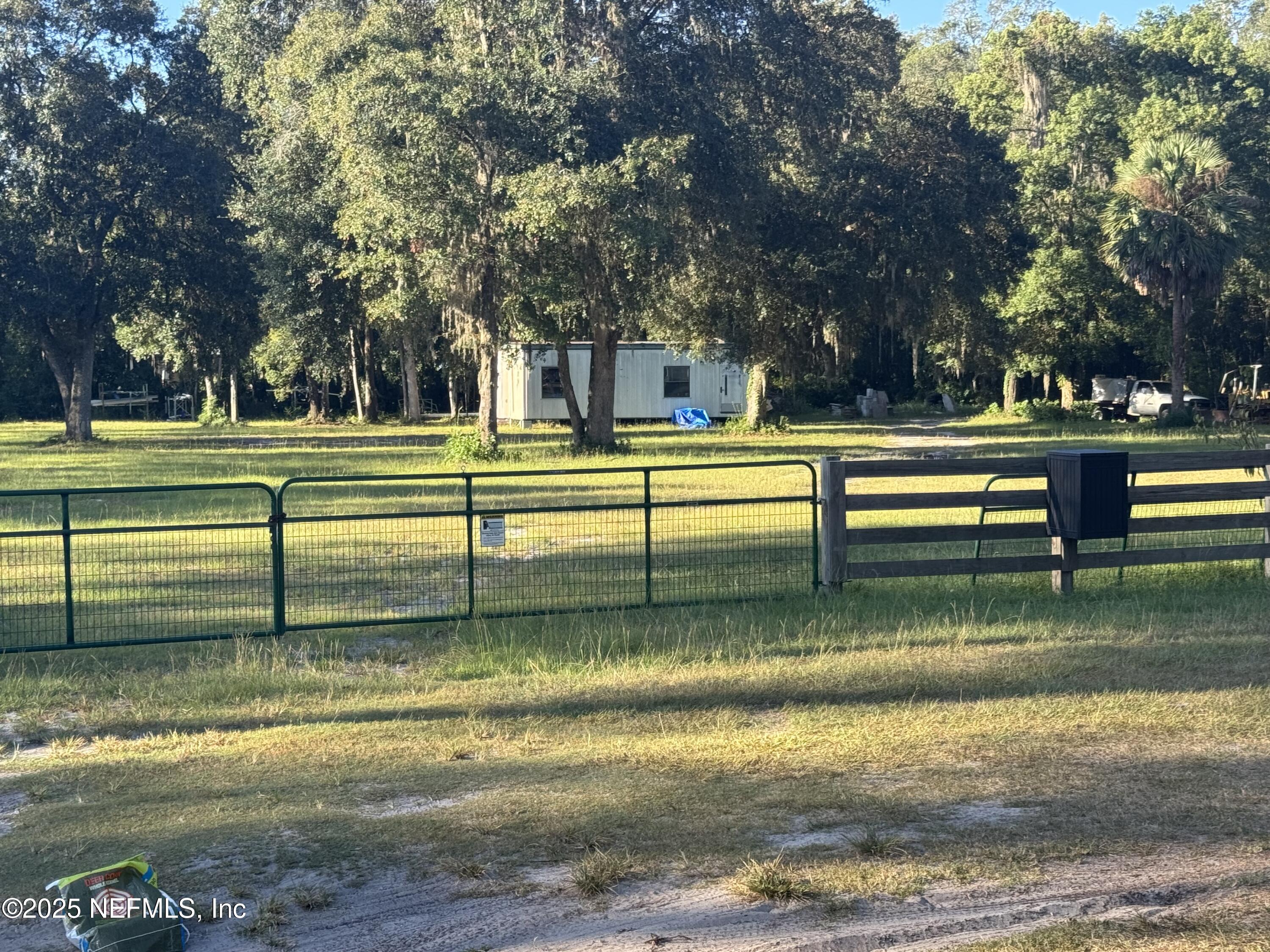 301 Northeast US Highway 301 Waldo, FL 32694 - Photo 1 of 56 a view of swimming pool with trees and sitting area