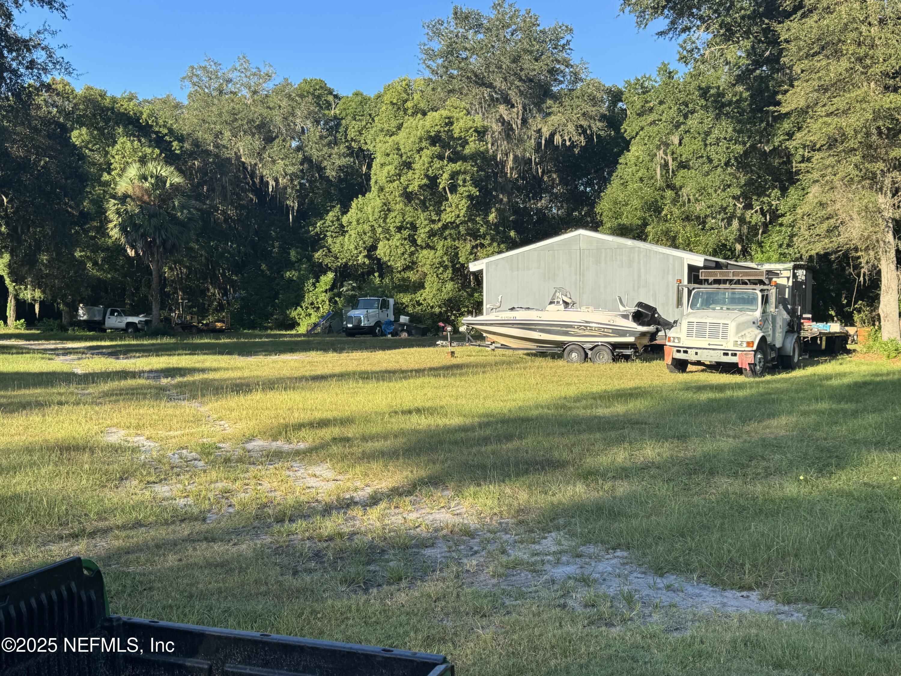 301 Northeast US Highway 301 Waldo, FL 32694 - Photo 28 of 56 a view of a swimming pool with lawn chairs and a big yard