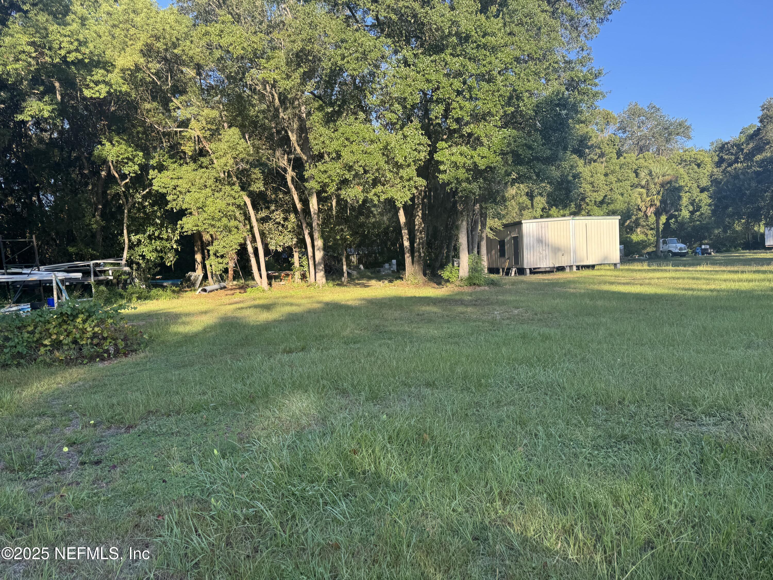 301 Northeast US Highway 301 Waldo, FL 32694 - Photo 6 of 56 a front view of a house with a yard and trees