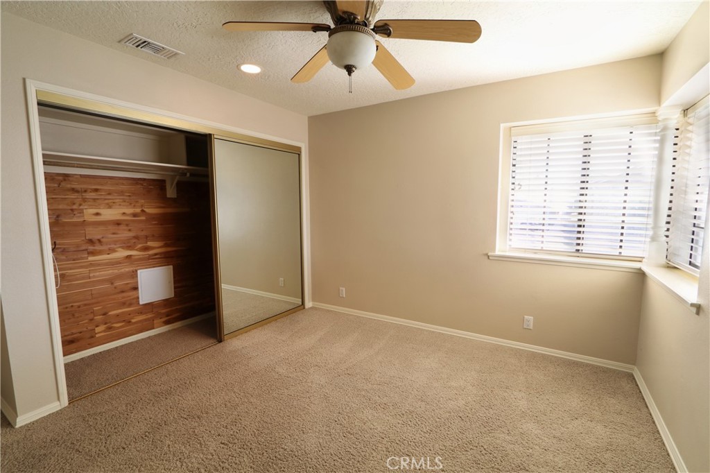 12885 Rain Shadow Road Victorville, CA 92395 - Photo 11 of 26 a view of an empty room with a window