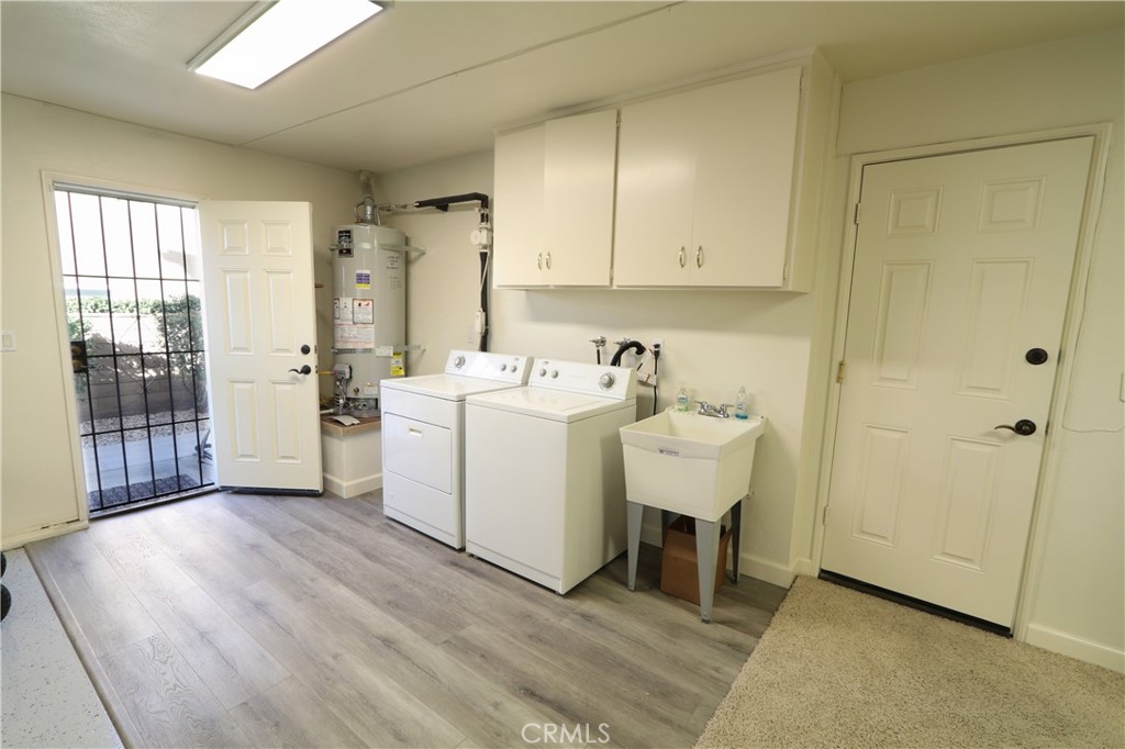 12885 Rain Shadow Road Victorville, CA 92395 - Photo 16 of 26 a utility room with dryer washer and a window