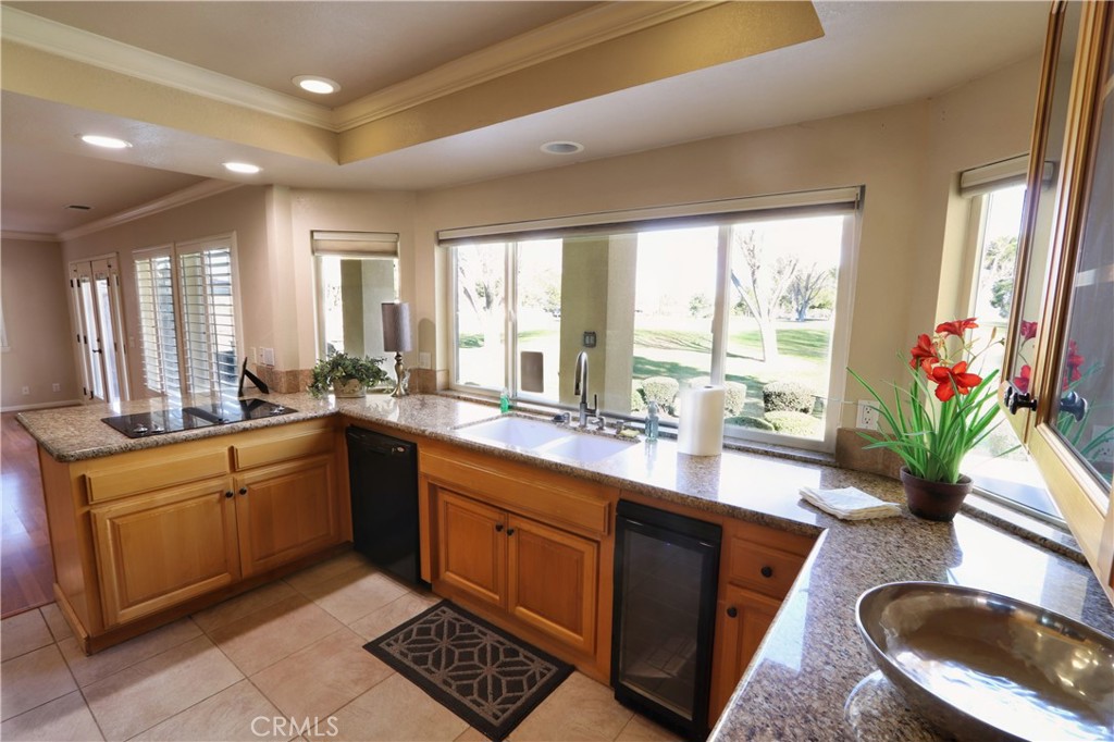 12885 Rain Shadow Road Victorville, CA 92395 - Photo 17 of 26 a large kitchen with kitchen island granite countertop a sink a window and a counter space