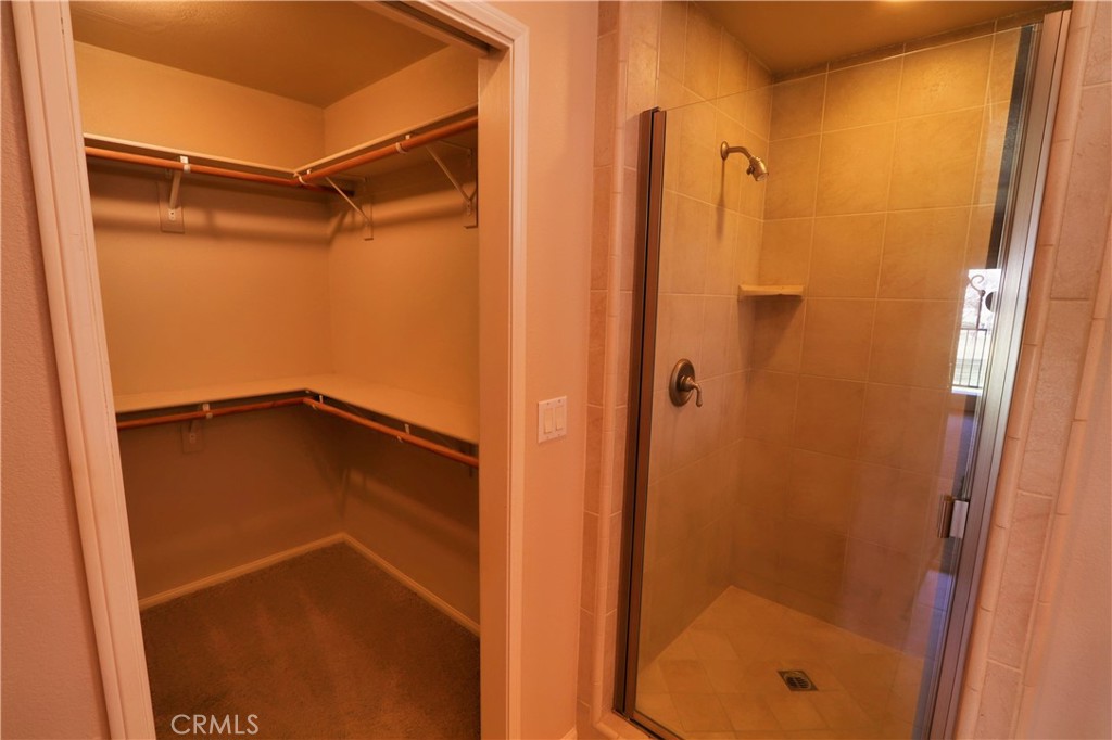 12885 Rain Shadow Road Victorville, CA 92395 - Photo 23 of 26 a bathroom with a shower and a window