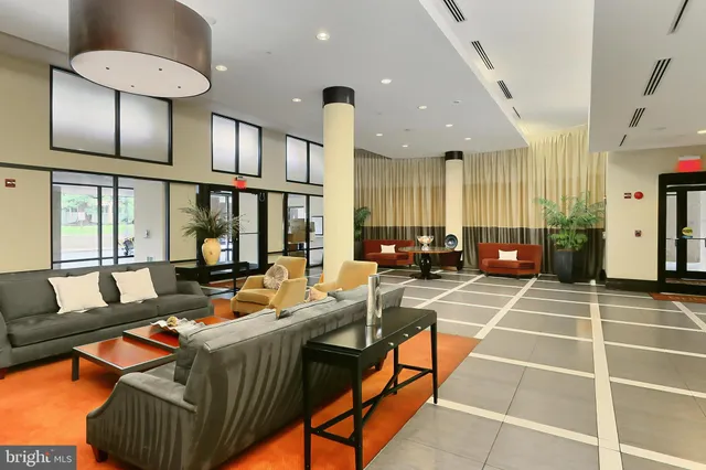 a living room with patio furniture and a chandelier