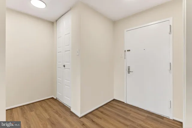 a view of an empty room with wooden floor