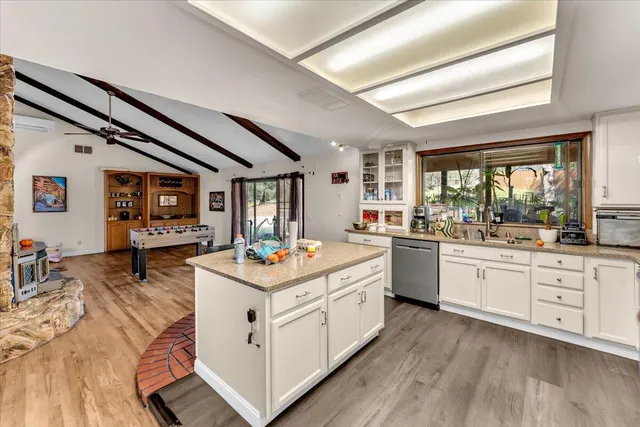 a kitchen with sink stove and wooden floor