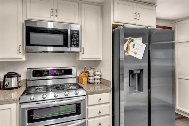 a kitchen with stainless steel appliances a stove a microwave and cabinets