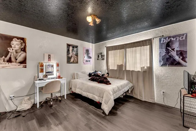 a bedroom with a bed and a desk