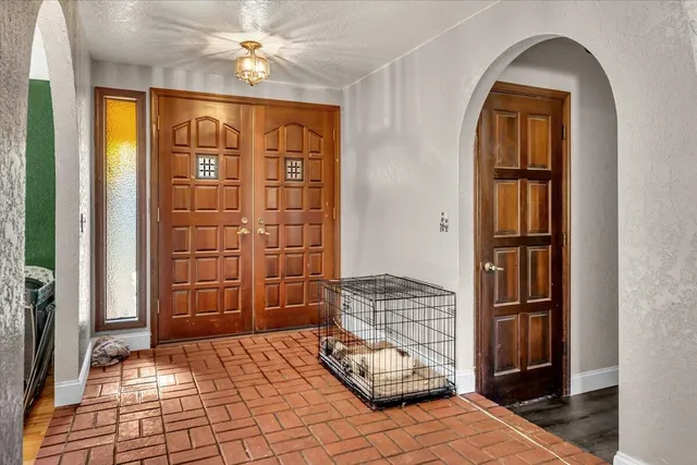 a bedroom with a bed and a chandelier