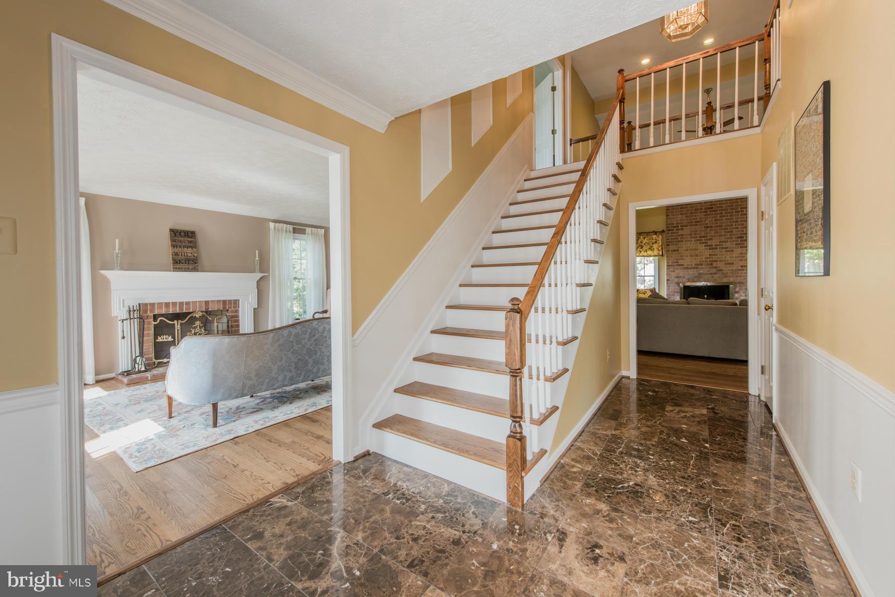 1206 Brookview Road Towson, MD 21286 - Photo 2 of 29 a view of a hallway to a livingroom with wooden floor and stairs