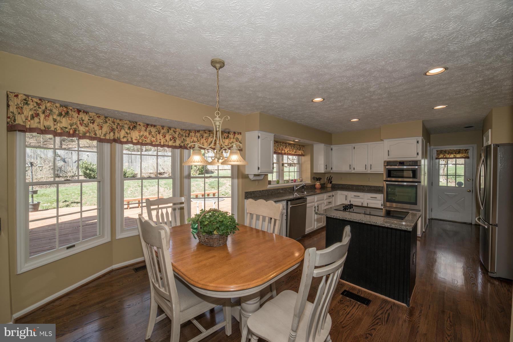1206 Brookview Road Towson, MD 21286 - Photo 14 of 29 a dining room with furniture and wooden floor