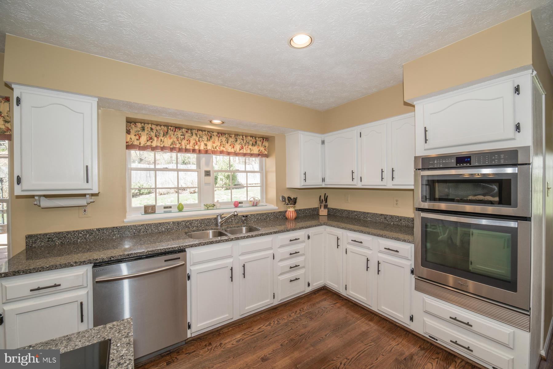 1206 Brookview Road Towson, MD 21286 - Photo 15 of 29 a kitchen with granite countertop cabinets stainless steel appliances and a sink