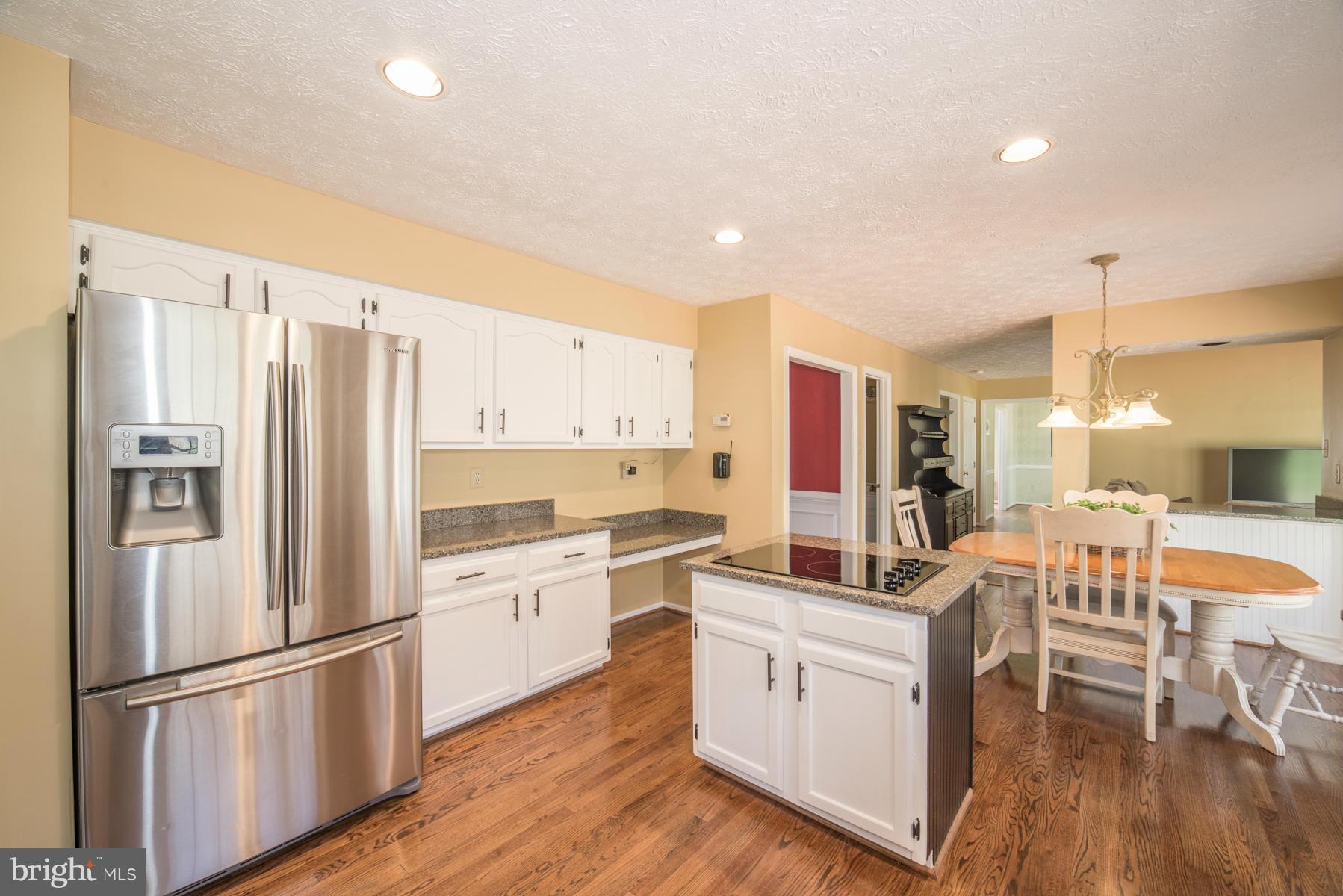 1206 Brookview Road Towson, MD 21286 - Photo 16 of 29 a kitchen with white cabinets and stainless steel appliances