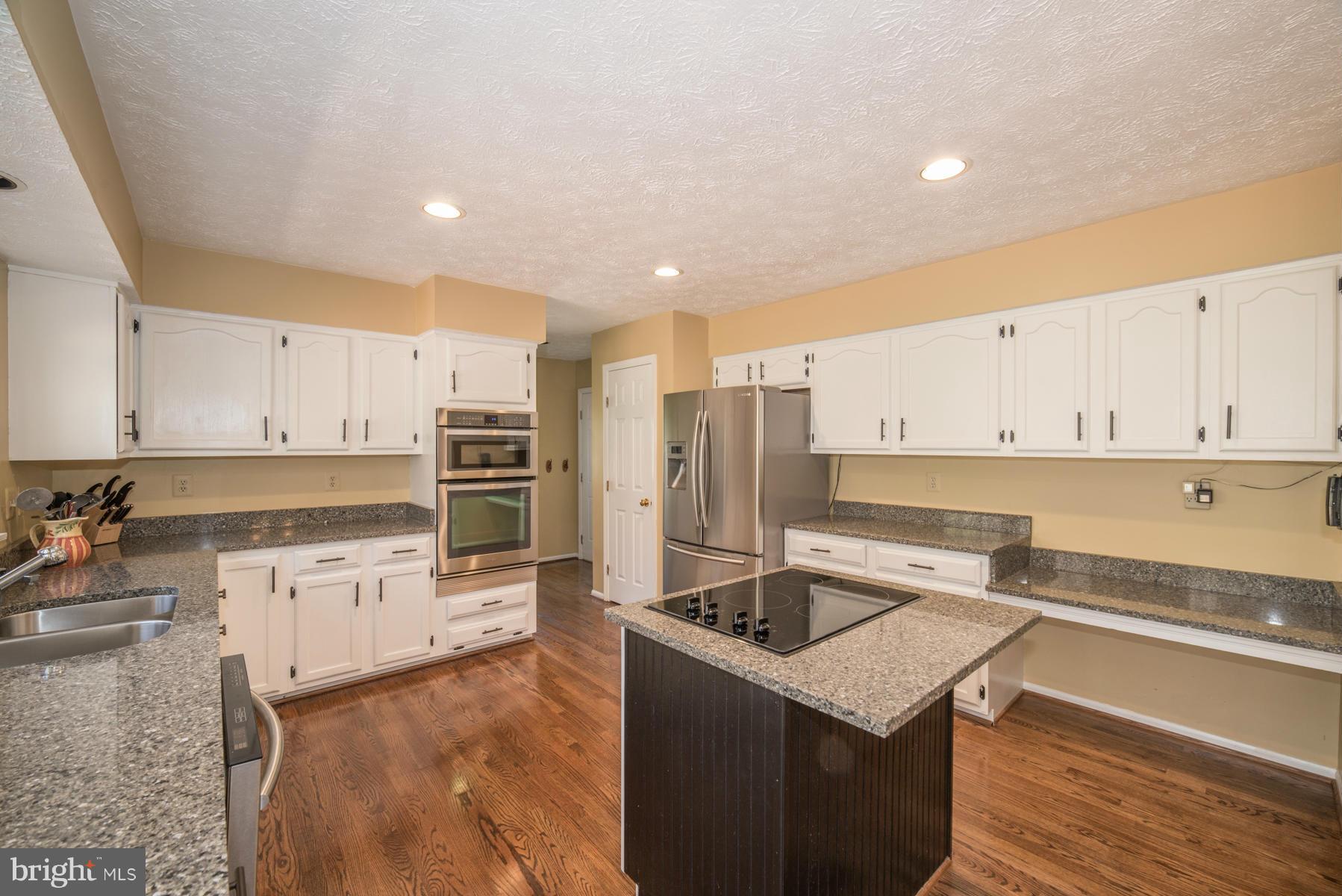 1206 Brookview Road Towson, MD 21286 - Photo 17 of 29 a kitchen with stainless steel appliances granite countertop a sink stove and refrigerator