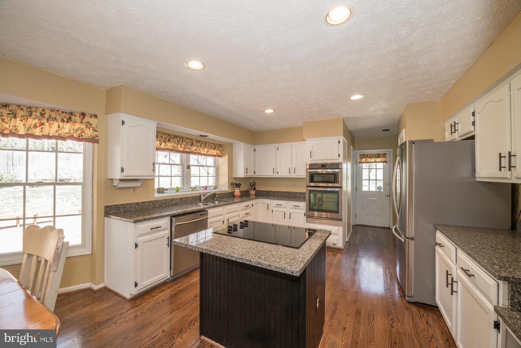 1206 Brookview Road Towson, MD 21286 - Photo 18 of 29 a kitchen with a sink wooden floor and stainless steel appliances