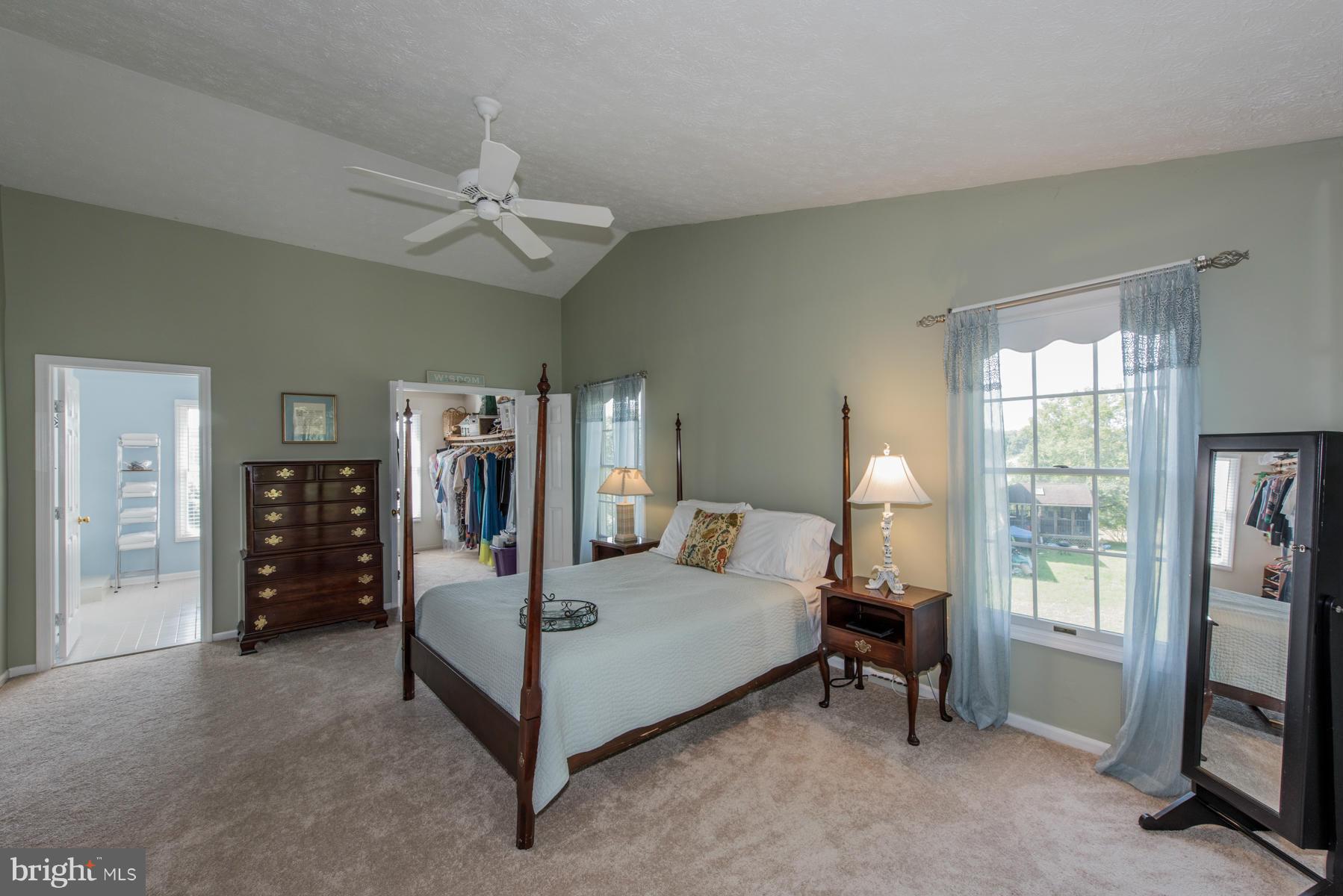 1206 Brookview Road Towson, MD 21286 - Photo 20 of 29 a bedroom with a bed a chandelier and a flat tv screen on dresser