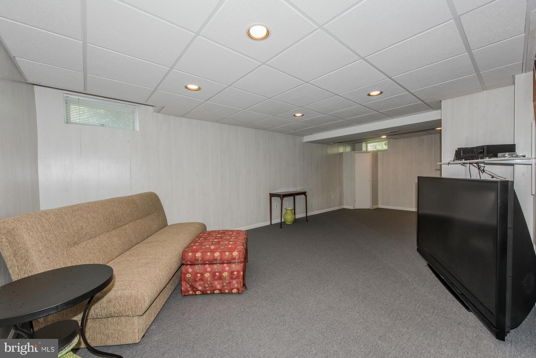 1206 Brookview Road Towson, MD 21286 - Photo 27 of 29 a living room with furniture and a flat screen tv