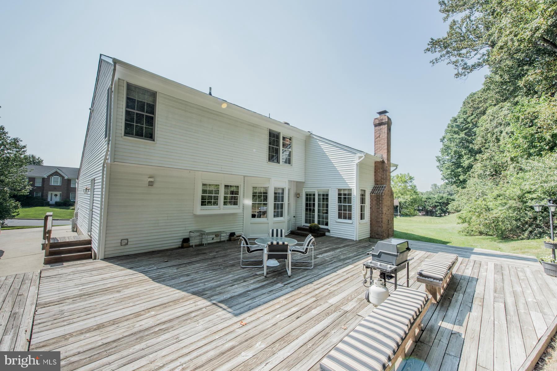 1206 Brookview Road Towson, MD 21286 - Photo 29 of 29 a view of a patio with couches table and chairs with wooden floor and fence