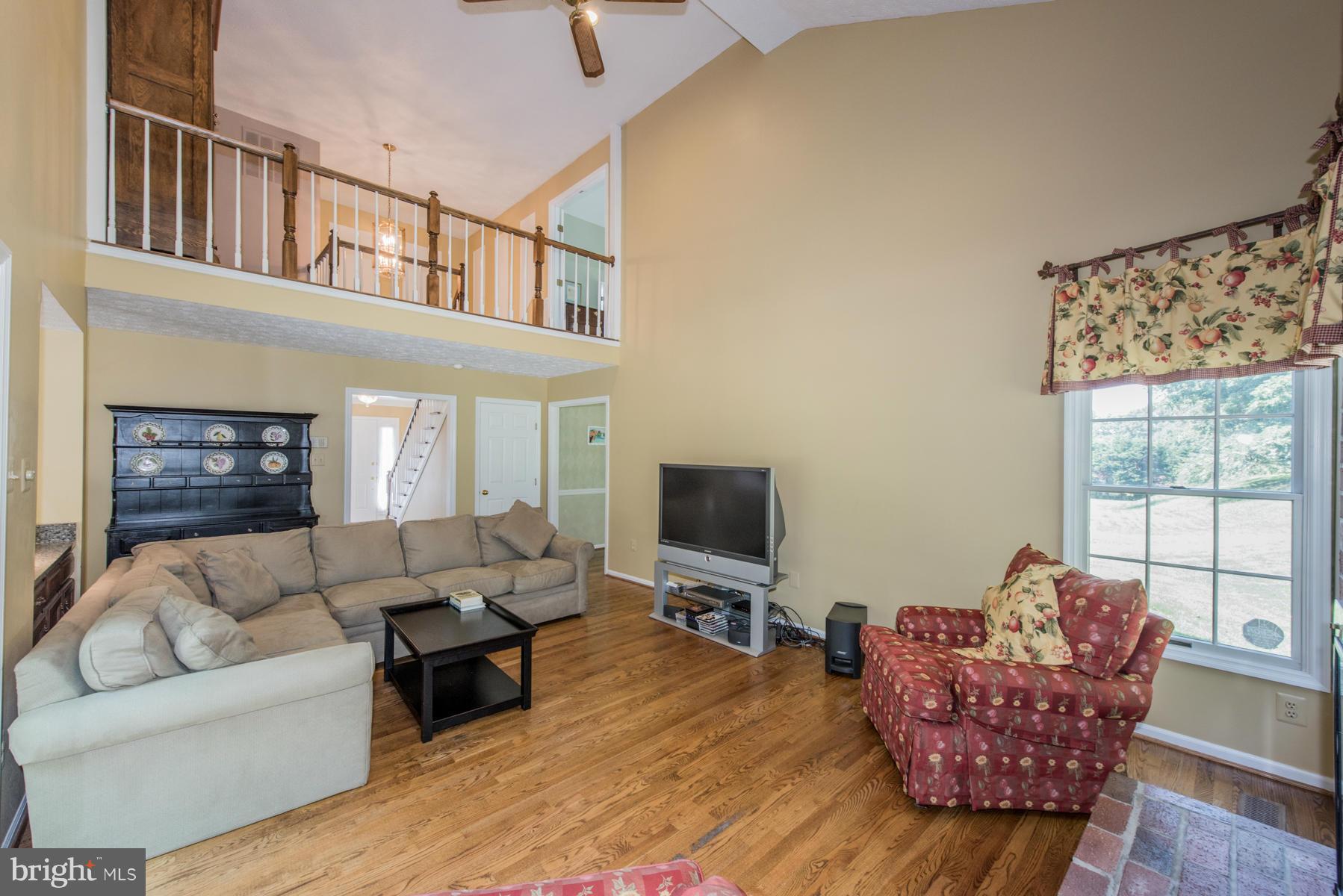 1206 Brookview Road Towson, MD 21286 - Photo 4 of 29 a living room with furniture a flat screen tv and a large window