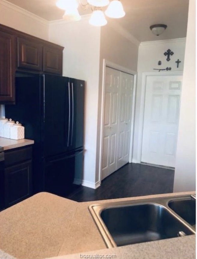 1425 West Villa Maria Road Bryan, TX 77801 - Photo 7 of 19 Kitchen featuring Laundry closet and entry door to the garage.