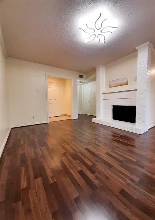 16301 Ledgemont Lane, Unit 207 Addison, TX 75001 - Photo 3 of 14 a view of empty room with wooden floor and fan