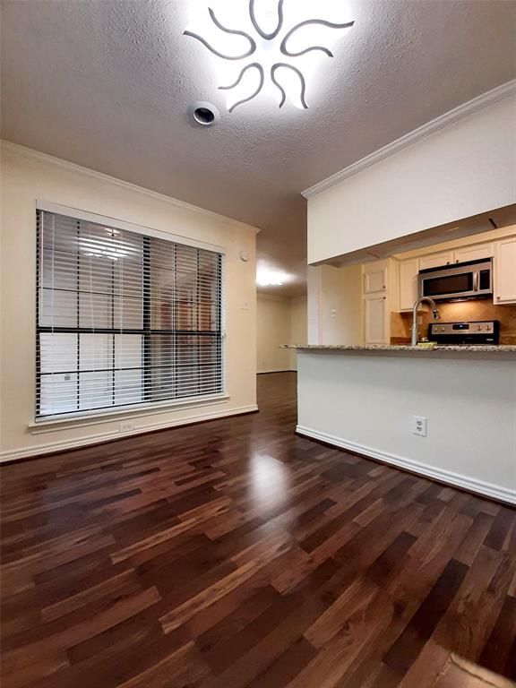 16301 Ledgemont Lane, Unit 207 Addison, TX 75001 - Photo 7 of 14 a view of a livingroom with wooden floor and a large window