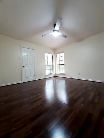 a view of wooden floor and windows in a room