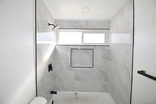 a bathroom with a bathtub and shower