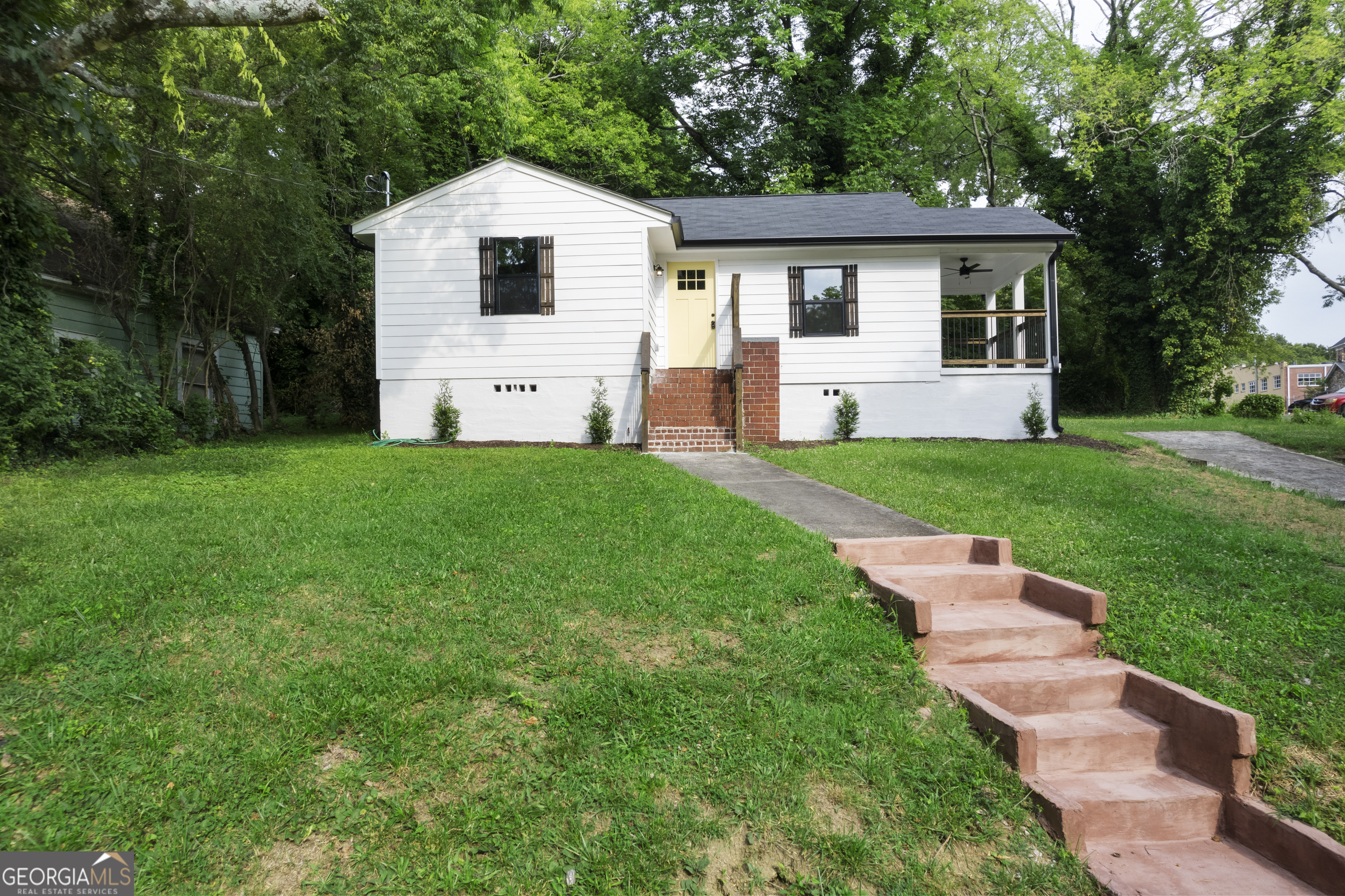 a front view of house with yard and green space