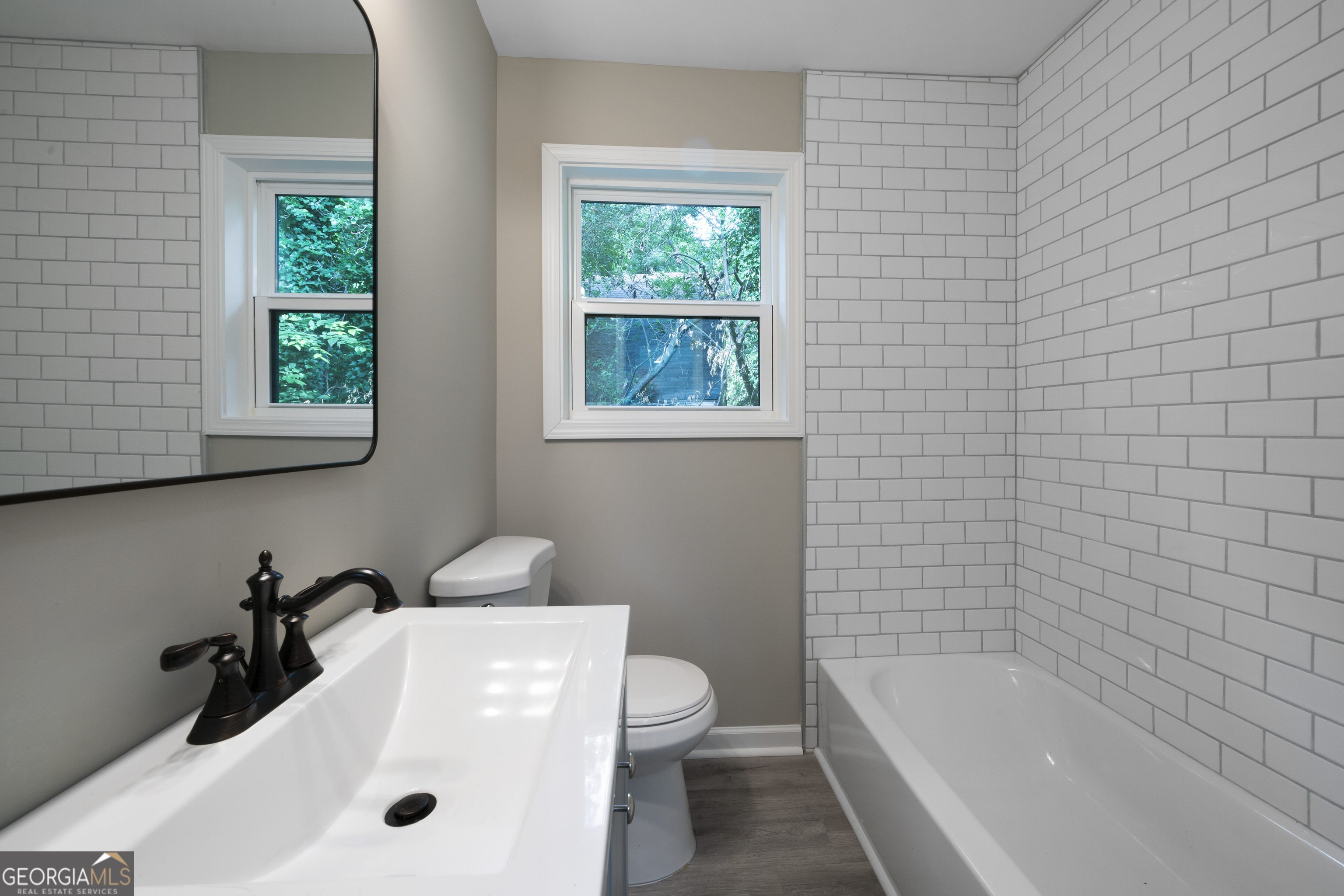 515 Harper Avenue Southwest Rome, GA 30161 - Photo 15 of 17 a bathroom with a tub a sink and a window