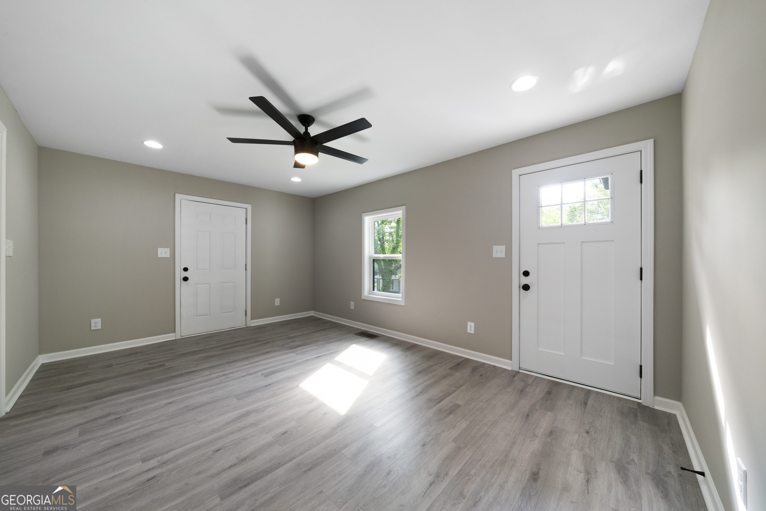 515 Harper Avenue Southwest Rome, GA 30161 - Photo 6 of 17 an empty room with wooden floor and windows