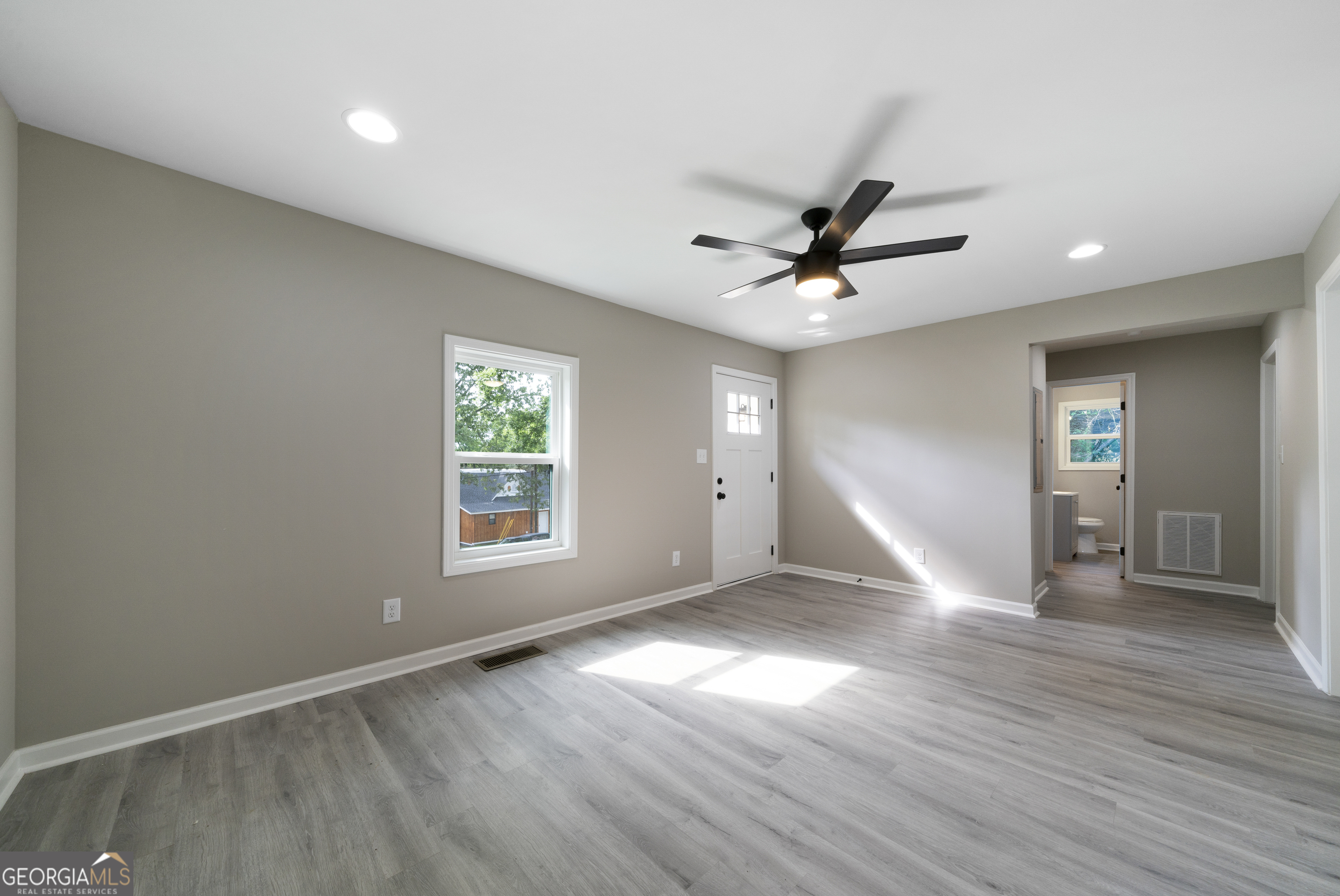 515 Harper Avenue Southwest Rome, GA 30161 - Photo 8 of 17 a view of empty room with wooden floor and fan