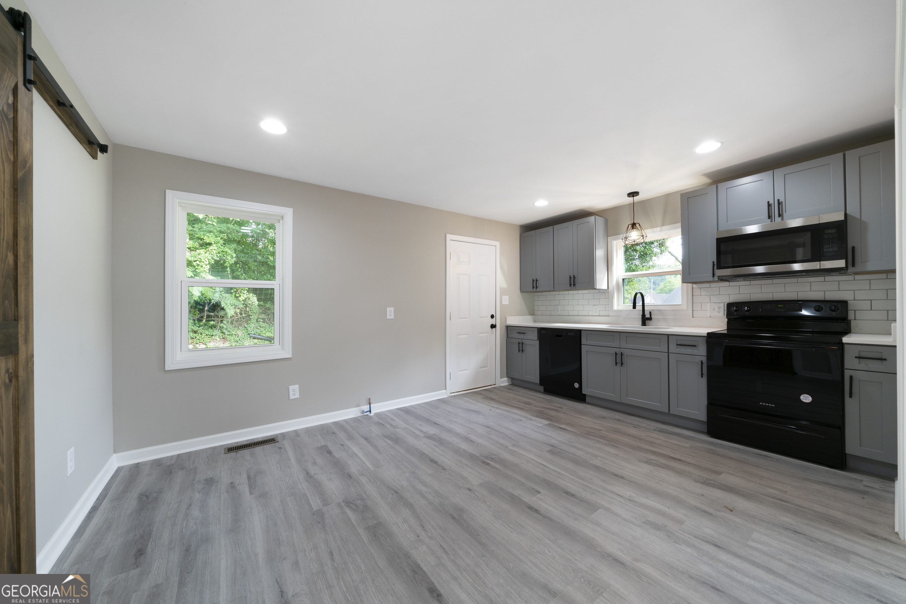 515 Harper Avenue Southwest Rome, GA 30161 - Photo 9 of 17 a kitchen with stainless steel appliances granite countertop a stove a sink and a microwave