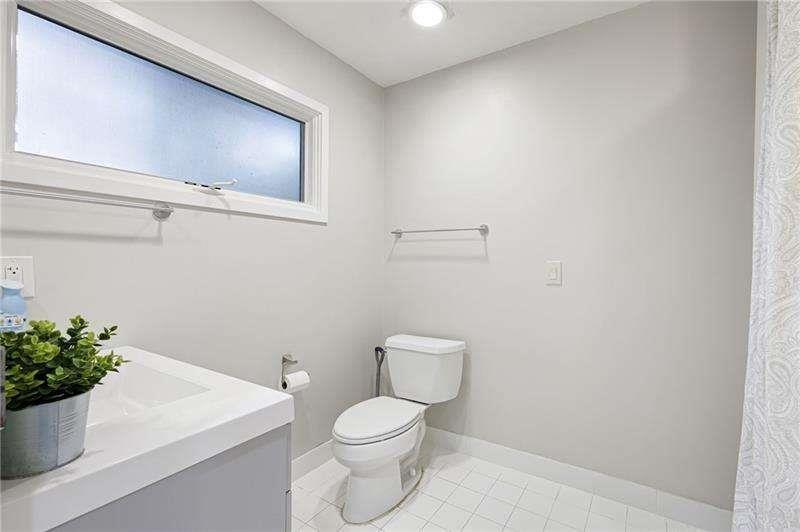 2176 Millennium Way Atlanta, GA 30319 - Photo 6 of 16 a white toilet sitting next to a white sink