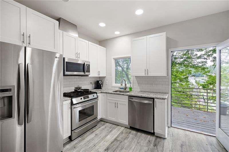 2176 Millennium Way Atlanta, GA 30319 - Photo 7 of 16 a kitchen with a stove a sink and a microwave