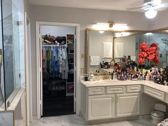 a bathroom with a sink vanity and a mirror