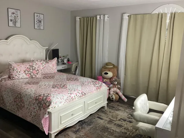 a bedroom with bed and a window