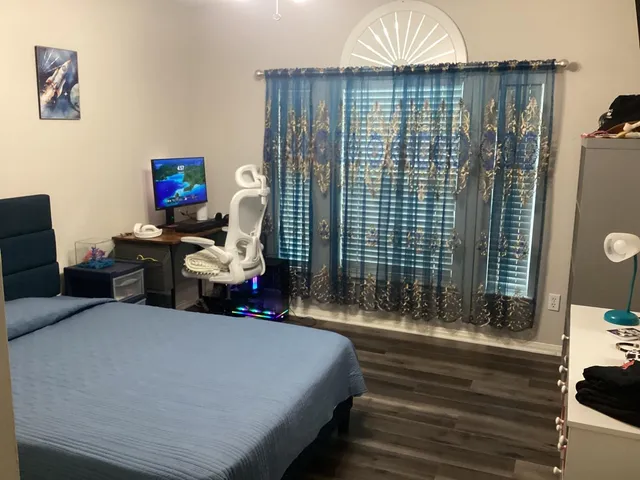 a bedroom with a bed and a television